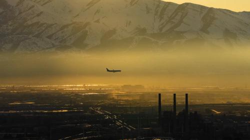 A plane flies into Salt Lake City International Airport as an inversion settles into the valley, diminishing the air quality in February 2022. Many west-siders, who suffer the most from air pollution, don't know how to plead their case to decision-makers.
